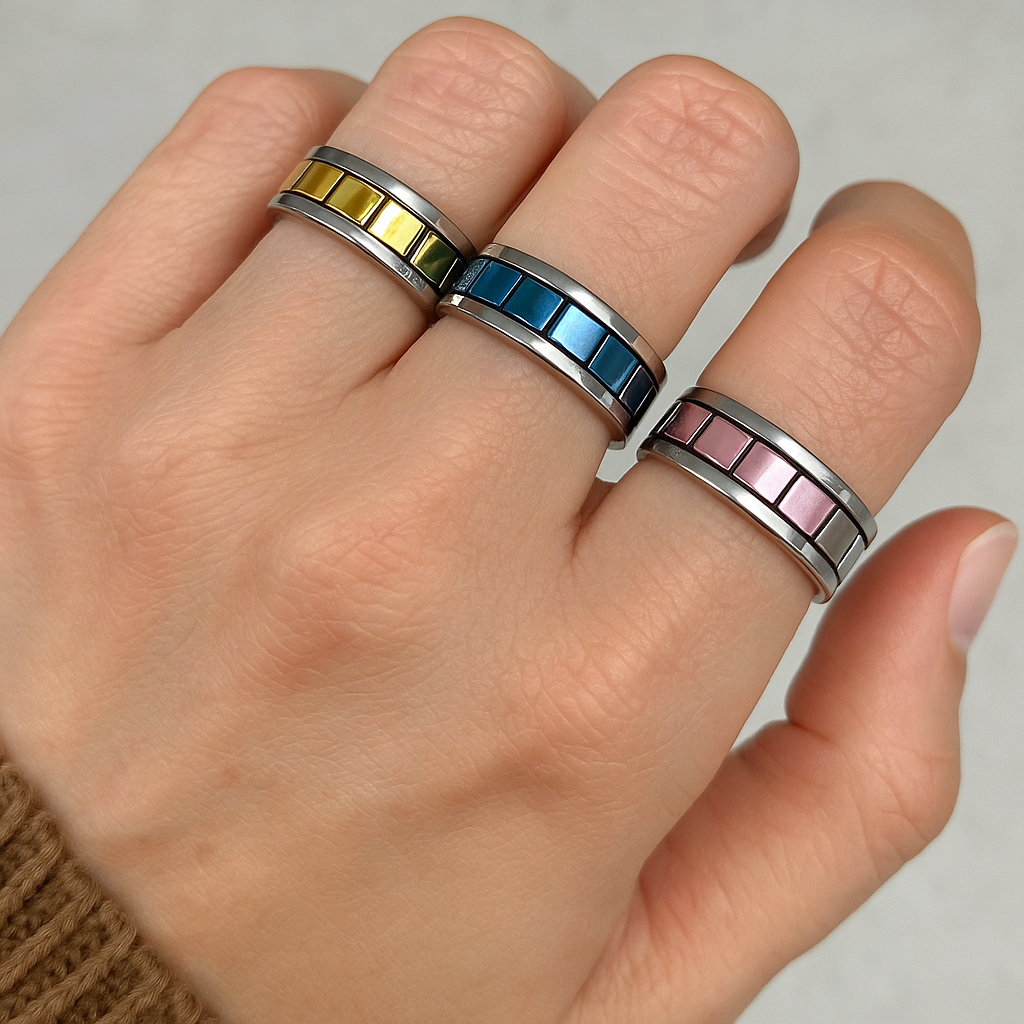 An image of a hand with mirrored chequer plate rings