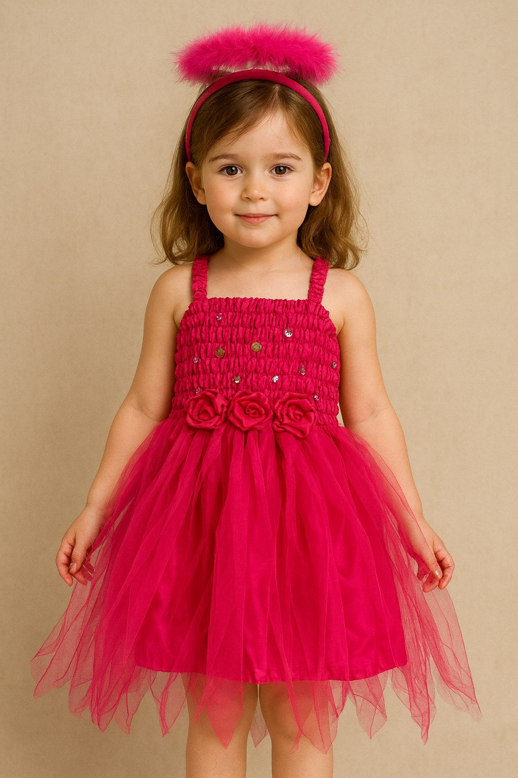 Young girl wearing a dark pink fairy dress with floral details on a beige background