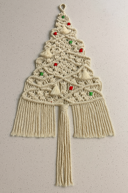 Macrame wall hanging designed like a Christmas tree with decorative elements on a plain background