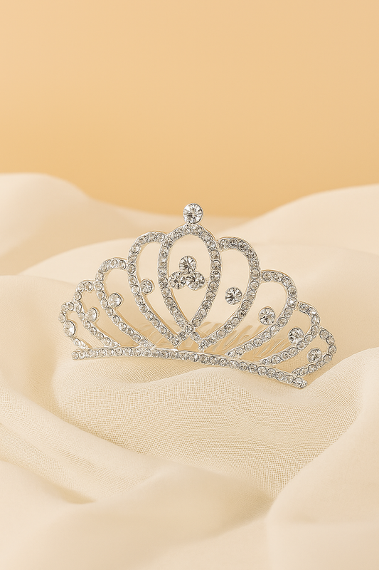 Silver tiara on a beige fabric background