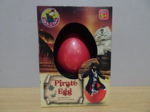 Pirate-themed product packaging with a red egg and pirate illustration on a wooden surface.