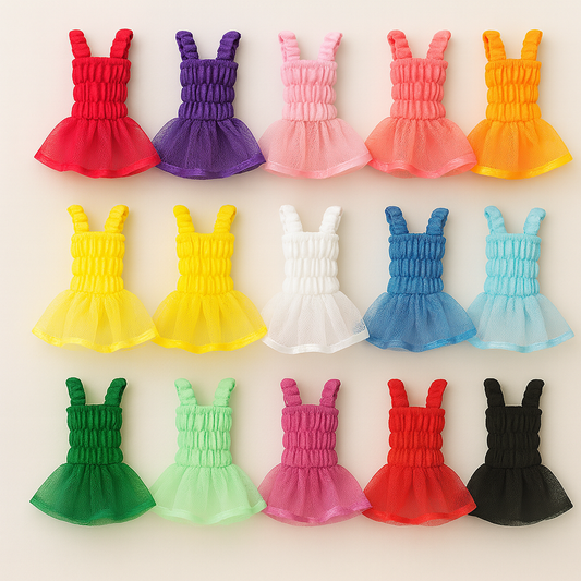 Row of colorful dresses on a beige background